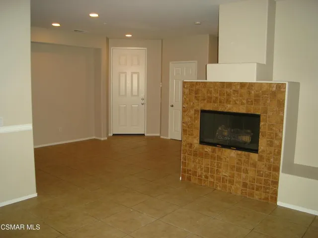 a view of an empty room with a fireplace