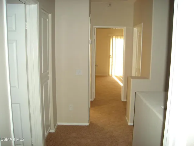 a white toilet sitting next to a white wall