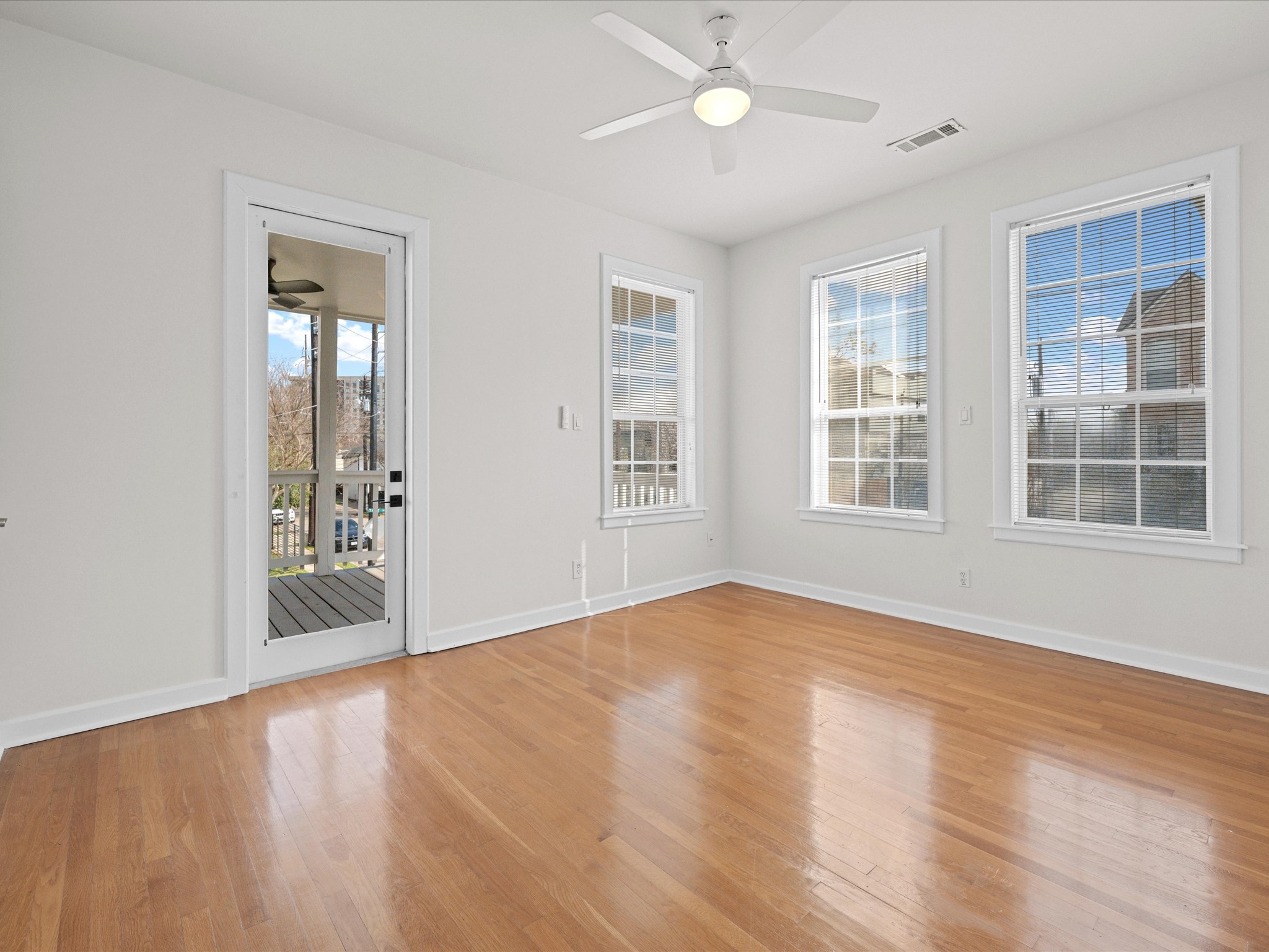 302 West Drew Street Houston, TX 77006 - Photo 24 of 48 a view of an empty room with a window and wooden floor