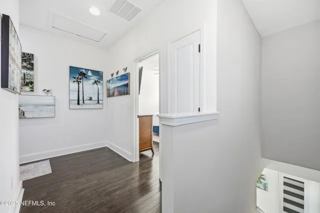 a view of hallway with wooden floor