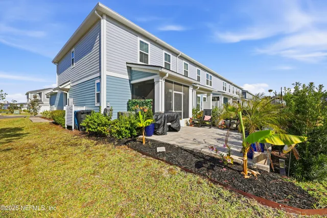 a view of a patio with table and chairs and potted plants