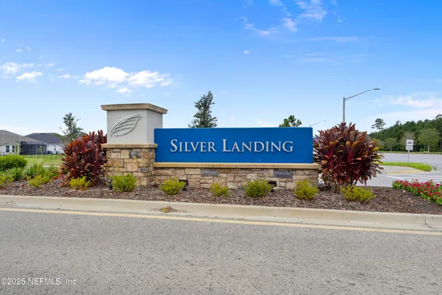 a front view of a house with a big yard and potted plants