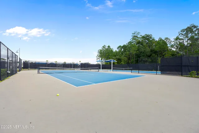 a view of a swimming pool with a table and chairs