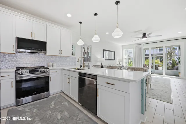 a large kitchen with cabinets and stainless steel appliances