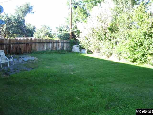 700 Wyoming Avenue Reno, NV 89503 - Photo 9 of 9 a view of a backyard with large trees and wooden fence