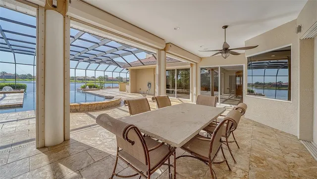 a living room with furniture kitchen view and a chandelier