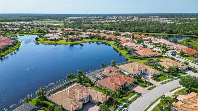 an aerial view of a houses with a swimming pool