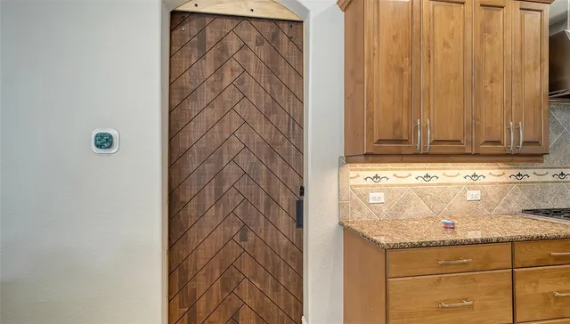 a bathroom with a granite countertop double vanity sink mirror and a toilet