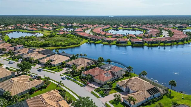 a view of a house with a yard and potted plants