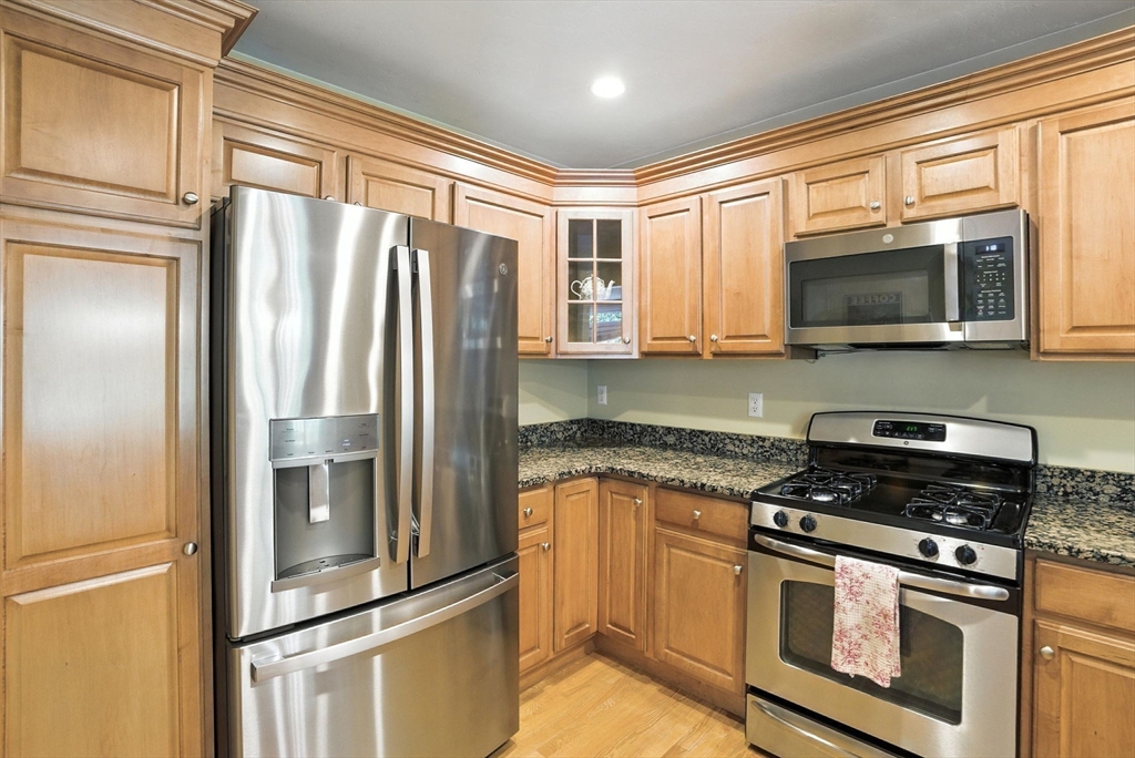 5 Trail Ridge Way, Unit C Harvard, MA 01451 - Photo 13 of 26 a kitchen with stainless steel appliances granite countertop a refrigerator stove and microwave