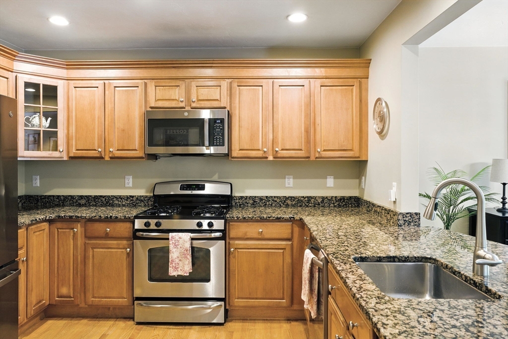 5 Trail Ridge Way, Unit C Harvard, MA 01451 - Photo 10 of 26 a kitchen with granite countertop a sink and a stove top oven