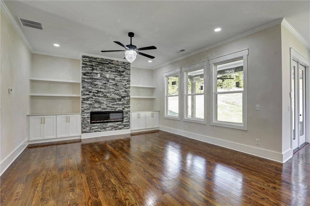 3629 Centerville Rosebud Road Snellville, GA 30039 - Photo 13 of 54 a living room with a fireplace and wooden floor