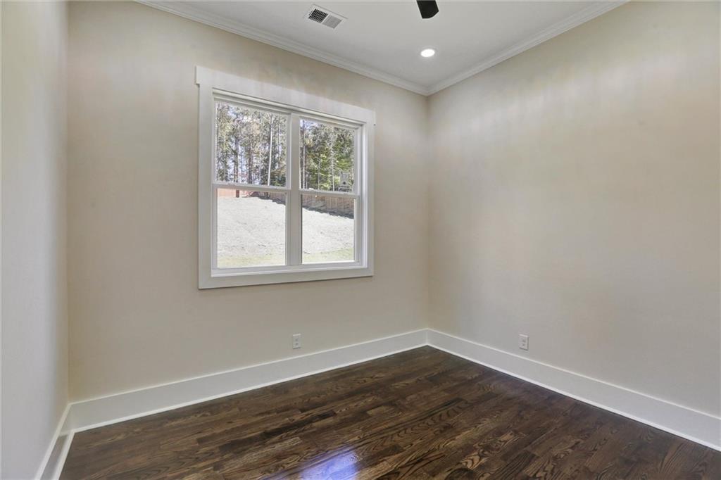 3629 Centerville Rosebud Road Snellville, GA 30039 - Photo 25 of 54 an empty room with wooden floor and windows