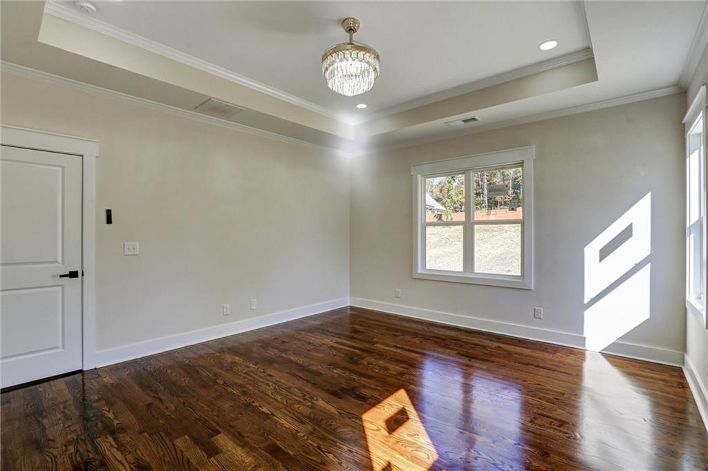 3629 Centerville Rosebud Road Snellville, GA 30039 - Photo 30 of 54 a view of an empty room with wooden floor and a window