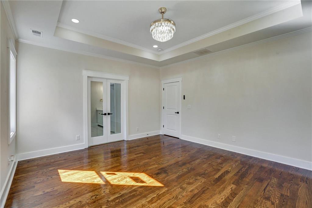 3629 Centerville Rosebud Road Snellville, GA 30039 - Photo 31 of 54 an empty room with wooden floor and a ceiling fan
