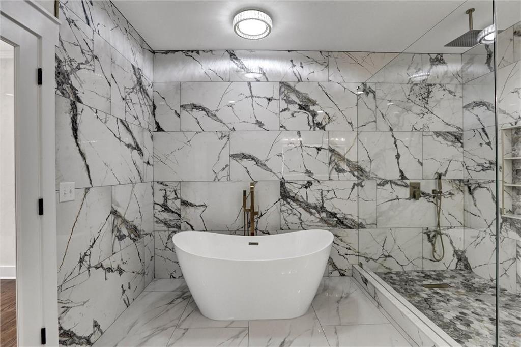 3629 Centerville Rosebud Road Snellville, GA 30039 - Photo 33 of 54 a white bath tub sitting in a bathroom