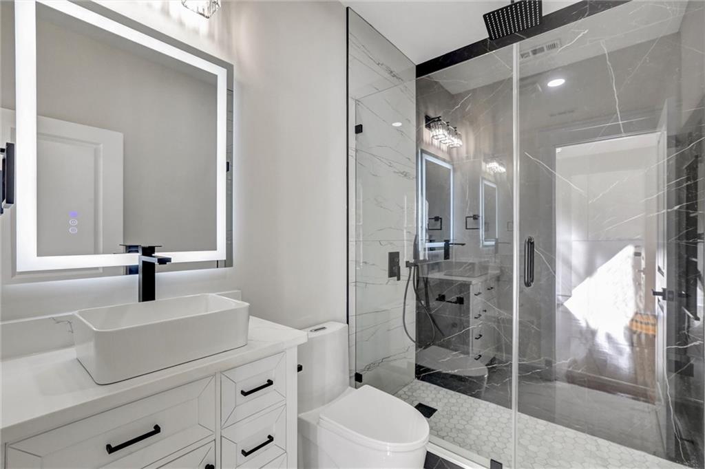 3629 Centerville Rosebud Road Snellville, GA 30039 - Photo 47 of 54 a bathroom with a sink a toilet and shower
