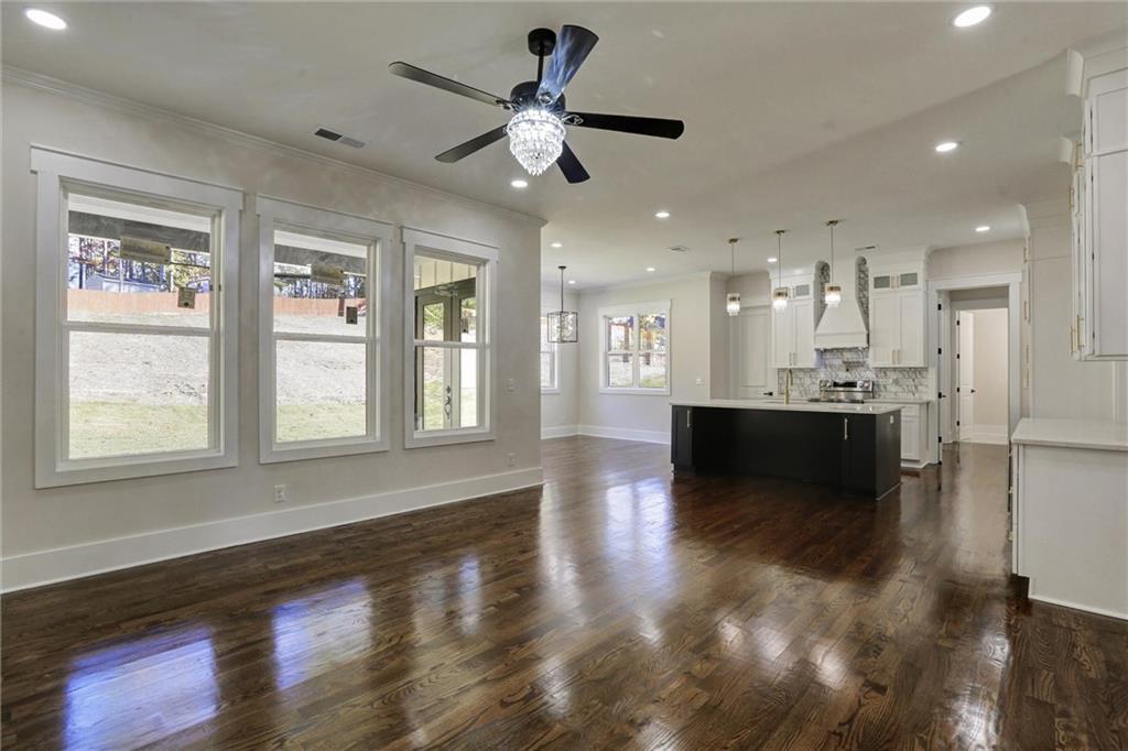 3629 Centerville Rosebud Road Snellville, GA 30039 - Photo 9 of 54 a view of an empty room and kitchen with wooden floor