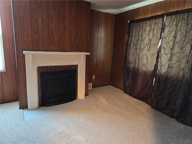 a view of an empty room with a fireplace