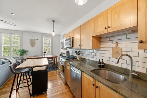 a kitchen with granite countertop a sink and cabinets