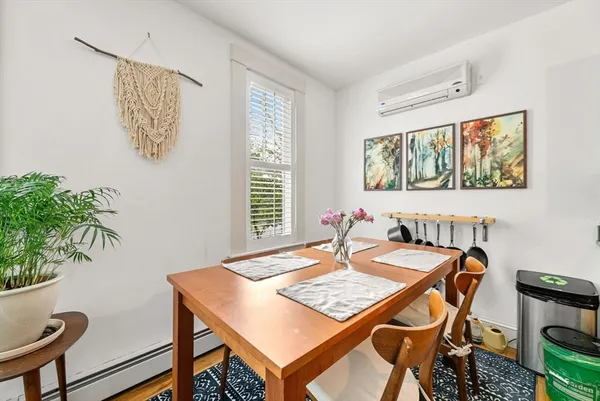 a view of a dining room with furniture window and wooden floor