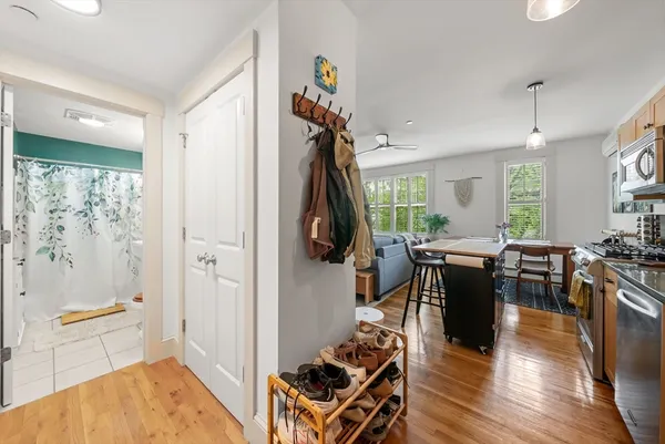 a living room with furniture a wooden floor and a window