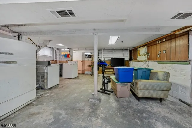 a work place with cabinets and refrigerator