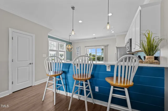 a view of a dining room with furniture and a window