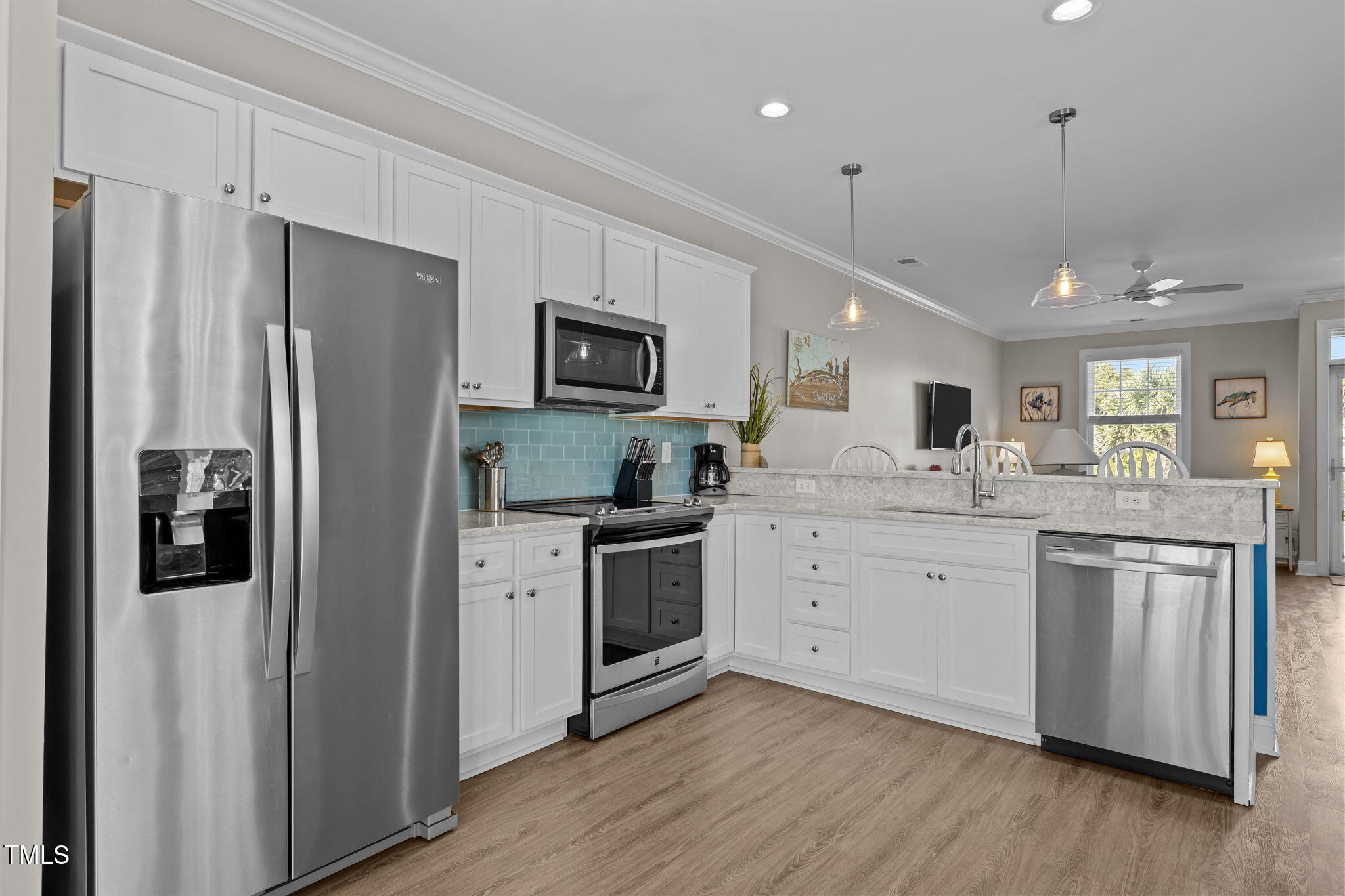 2800 West Fort Macon Road, Unit 37 Atlantic Beach, NC 28512 - Photo 9 of 39 a kitchen with white cabinets and stainless steel appliances