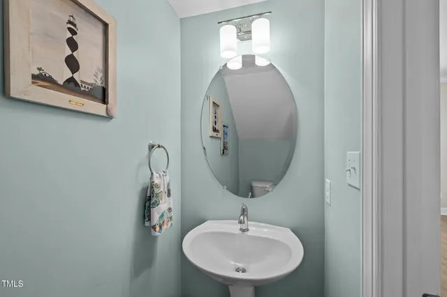 a bathroom with a mirror sink and vanity