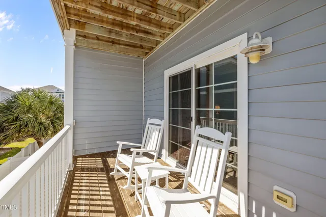 a view of balcony with wooden floor and outdoor seating