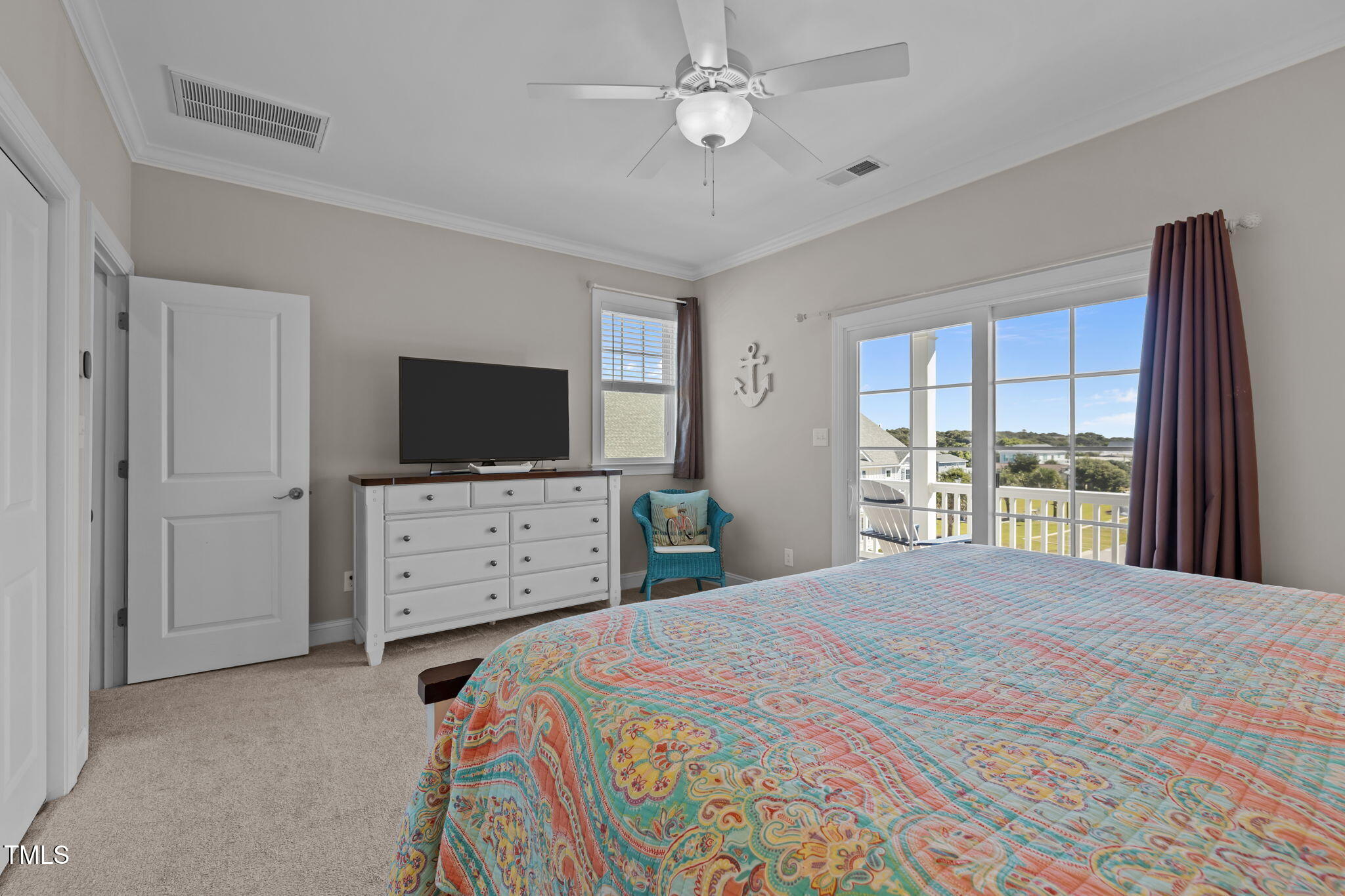 2800 West Fort Macon Road, Unit 37 Atlantic Beach, NC 28512 - Photo 26 of 39 a bedroom with a bed and a flat screen tv in it
