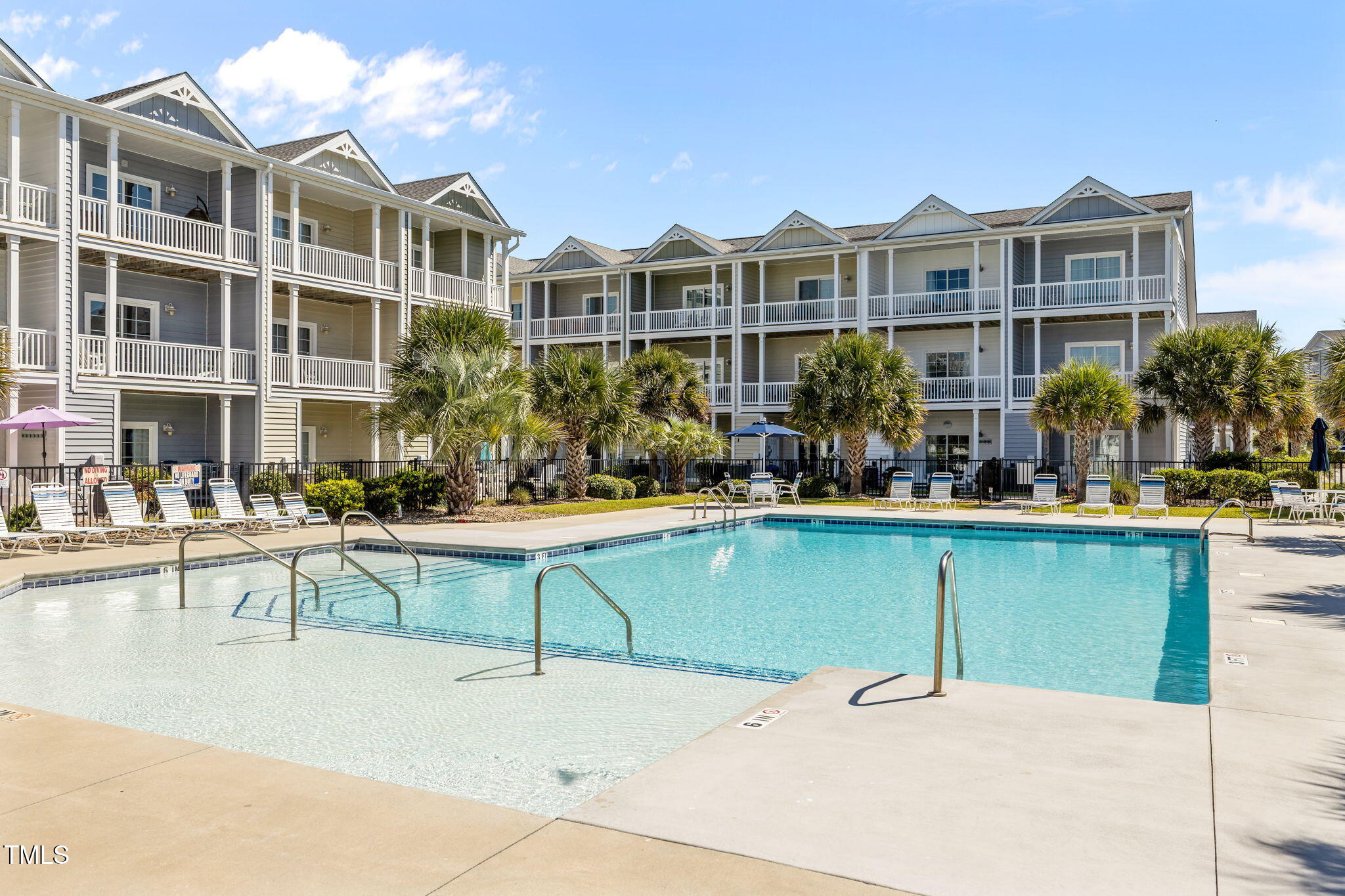 2800 West Fort Macon Road, Unit 37 Atlantic Beach, NC 28512 - Photo 2 of 39 a swimming pool with outdoor seating and yard