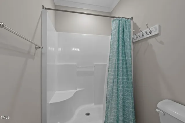 a bathroom with a shower and a toilet