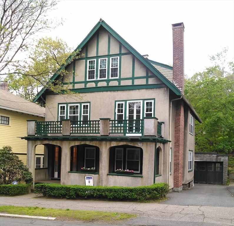111 Sumner Road, Unit 1 Brookline, MA 02445 - Photo 1 of 1 a front view of a house with garden
