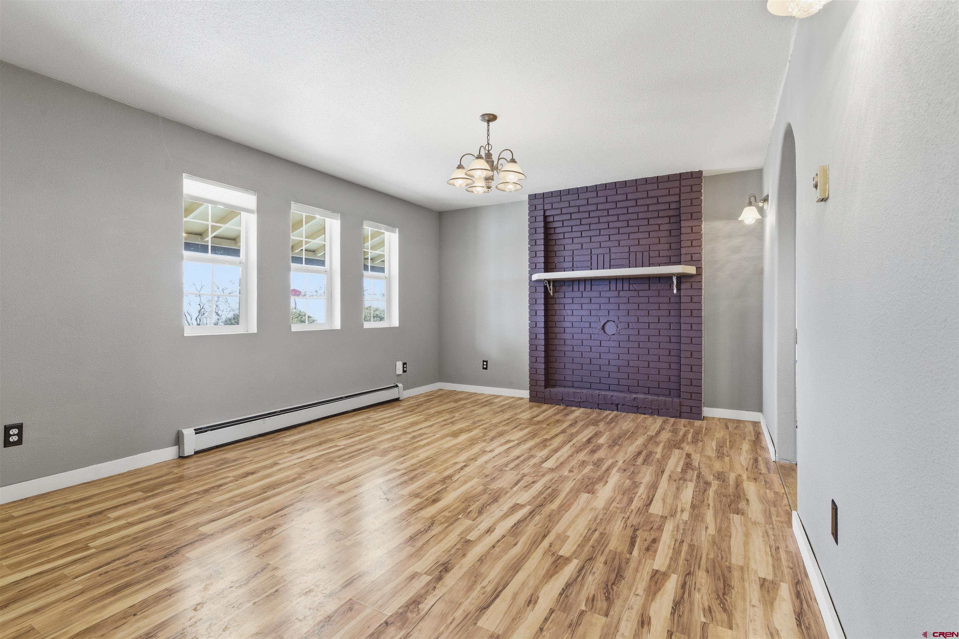 16216 2600th Road Cedaredge, CO 81413 - Photo 2 of 45 a view of an empty room with wooden floor and windows