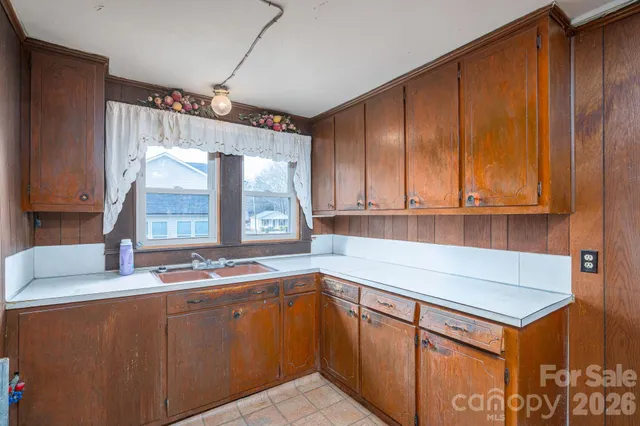 a kitchen with stainless steel appliances granite countertop a sink and a cabinets