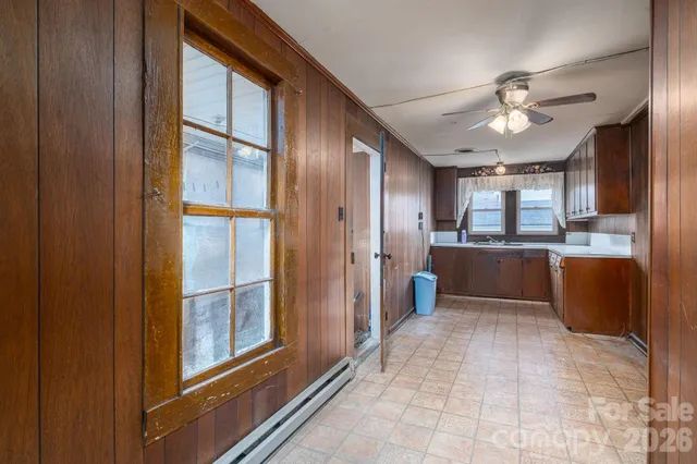 a view of kitchen with windows and refrigerator