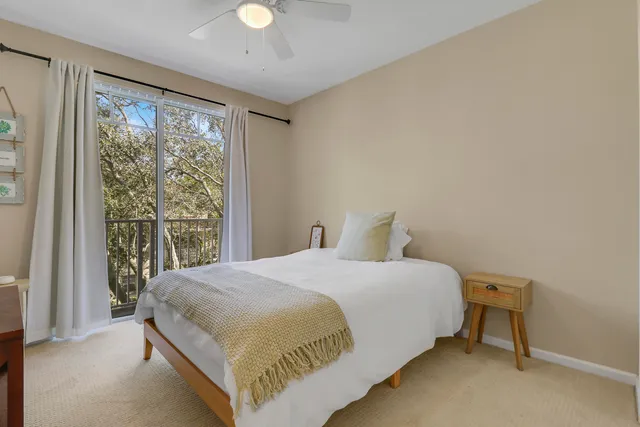 a bedroom with a bed lamp and window