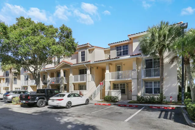 a front view of a residential apartment building with trees
