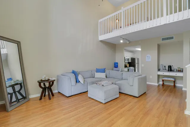 a living room with furniture and a wooden floor
