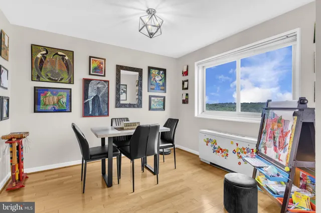 a view of a dining room with furniture a rug and wooden floor