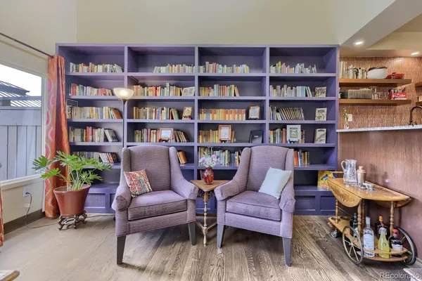 a living room with furniture and a book shelf