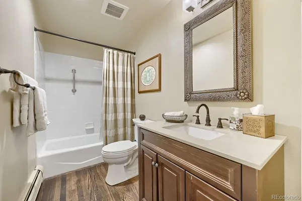 a bathroom with a sink a toilet and a large mirror
