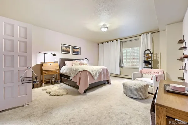 a bedroom with bed and a couch