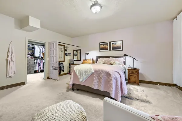 a bedroom with a large bed and a couch