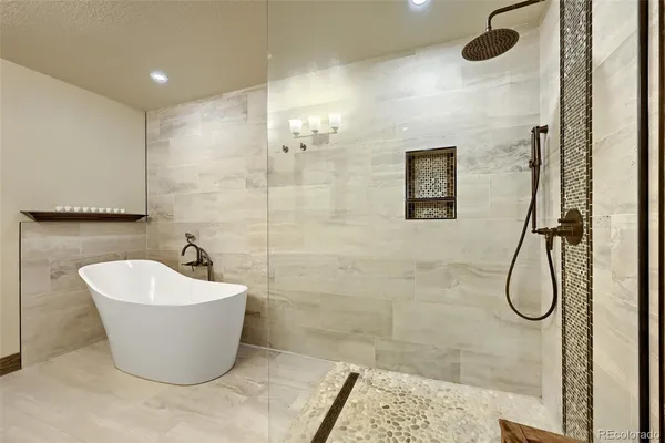 a white tub sitting next to a shower