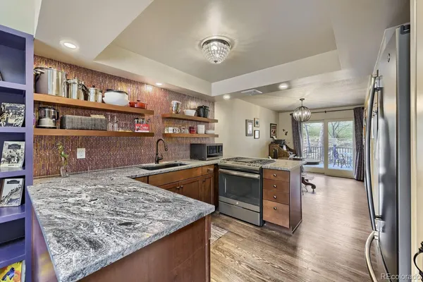a kitchen with stainless steel appliances granite countertop a stove and a sink
