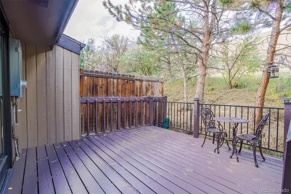 a balcony with wooden floor and fence