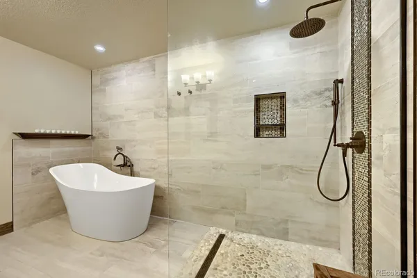 a white tub sitting next to a shower